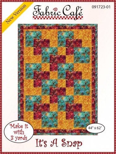May include: A quilting pattern for a quilt called 'It's A Snap' by Fabric Cafe. The pattern features a red, teal, and gold color scheme. The quilt is 44 inches by 62 inches and requires 3 yards of fabric. The pattern is labeled 'New Version' and '091723-01'.