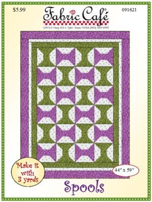 May include: A quilting pattern for a quilt called 'Spools' from Fabric Cafe. The pattern features a green and purple design with a bow tie motif. The pattern is 44 inches by 59 inches and requires 3 yards of fabric. The price is $5.99. The pattern number is 091621.