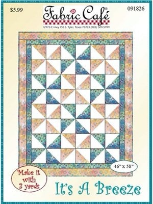 May include: Quilt pattern for a quilt called 'It's A Breeze' with a blue, green, and orange color scheme. The pattern is 46 inches by 58 inches and requires 3 yards of fabric. The pattern is from Fabric Cafe.