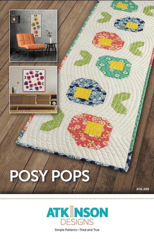 May include: Posy Pops quilting pattern by Atkinson Designs. The pattern features a table runner with a repeating design of colorful flowers. The text on the pattern reads 'Posy Pops' and 'ATK-209'. The pattern is described as 'Simple Patterns - Tried and True'.
