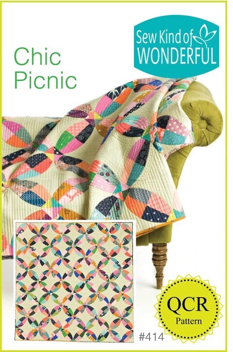 May include: A quilt pattern called 'Chic Picnic' by Sew Kind of Wonderful. The pattern is a quilt block design with a repeating pattern of circles and curved lines. The quilt is made with a variety of colorful fabrics in pink, blue, green, orange, and white. The quilt is displayed on a green sofa with a brown wooden leg. The pattern number is #414. The text 'QCR Pattern' is displayed on a yellow circle with black dots around the edge.