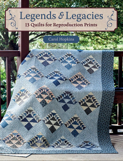 May include: A blue and white quilt with a geometric pattern. The quilt is folded and sitting on a wooden porch. The title "Legends & Legacies 13 Quilts for Reproduction Prints" is displayed above the quilt. The author's name, "Carol Hopkins", is displayed below the quilt.